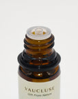 Macro close-up of the built-in dropper reducer cap on a Vaucluse essential oil amber glass bottle.