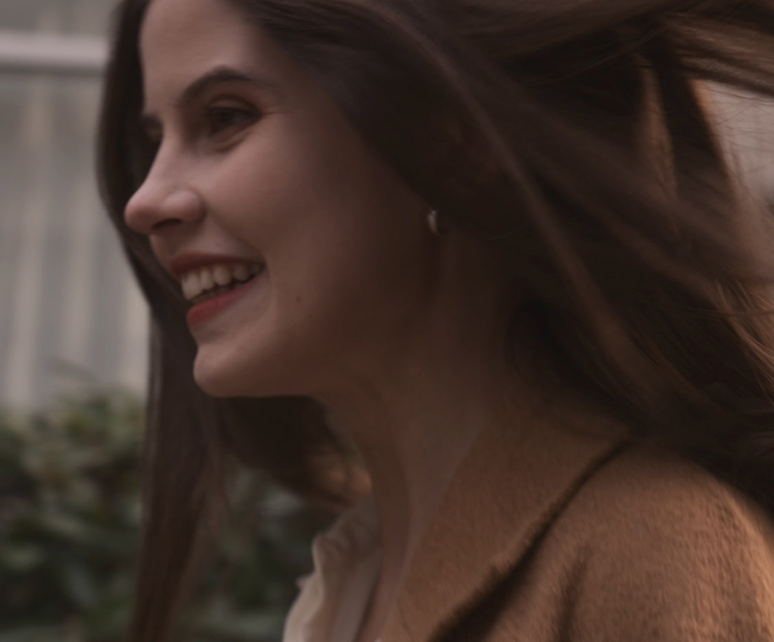 Close-up lifestyle portrait of a smiling woman embodying the luxury wellness and premium experience of the Vaucluse home fragrance brand