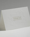 An elegant, freestanding white thank you card featuring debossed floral motifs surrounding the text "I Appreciate You, Thank You For Everything."