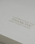 Close-up macro shot showcasing the high-quality textured cardstock and fine debossed details of the Vaucluse appreciation note.