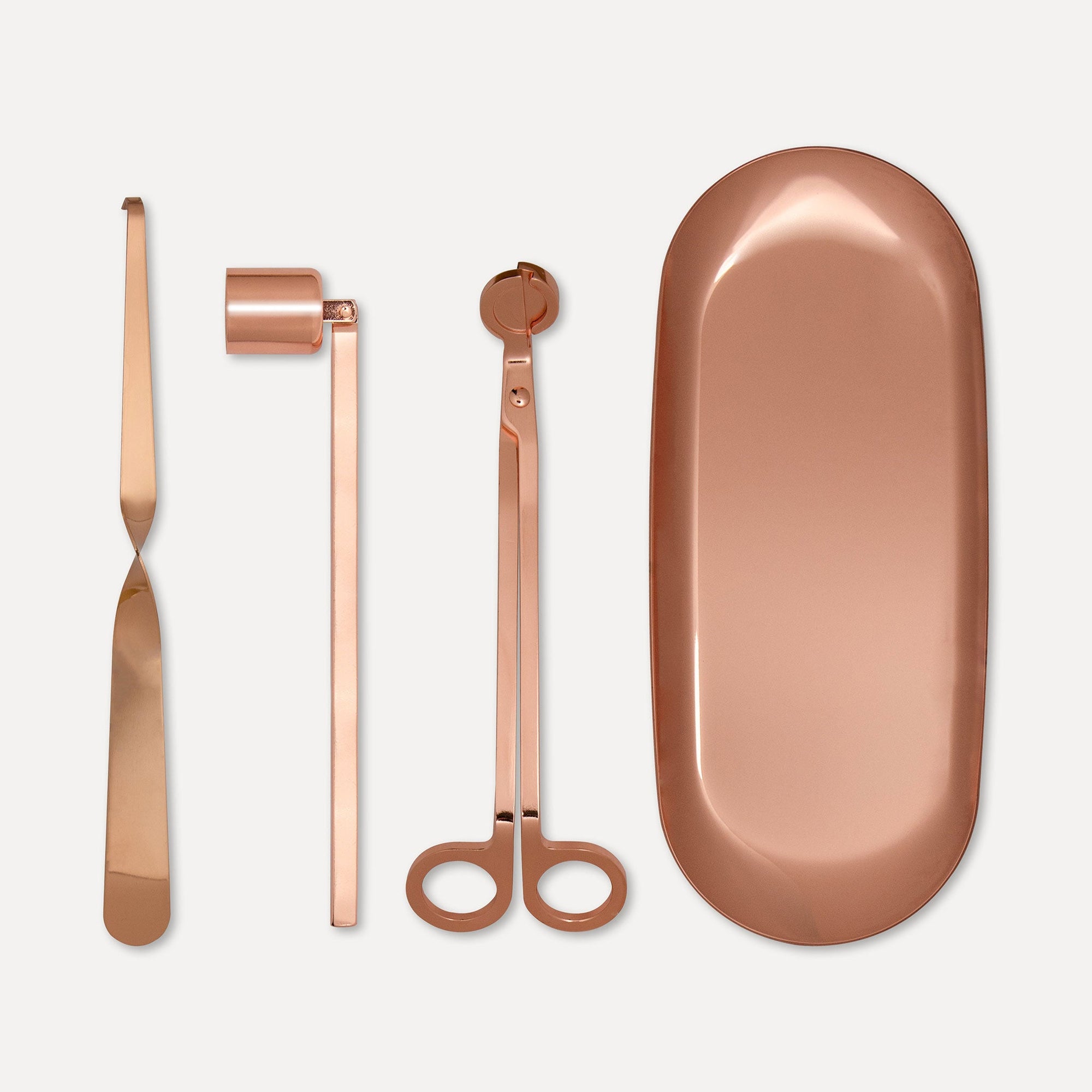 Premium rose gold candle care accessory set featuring a wick trimmer, candle snuffer, wick dipper, and matching oval tray on a clean background.