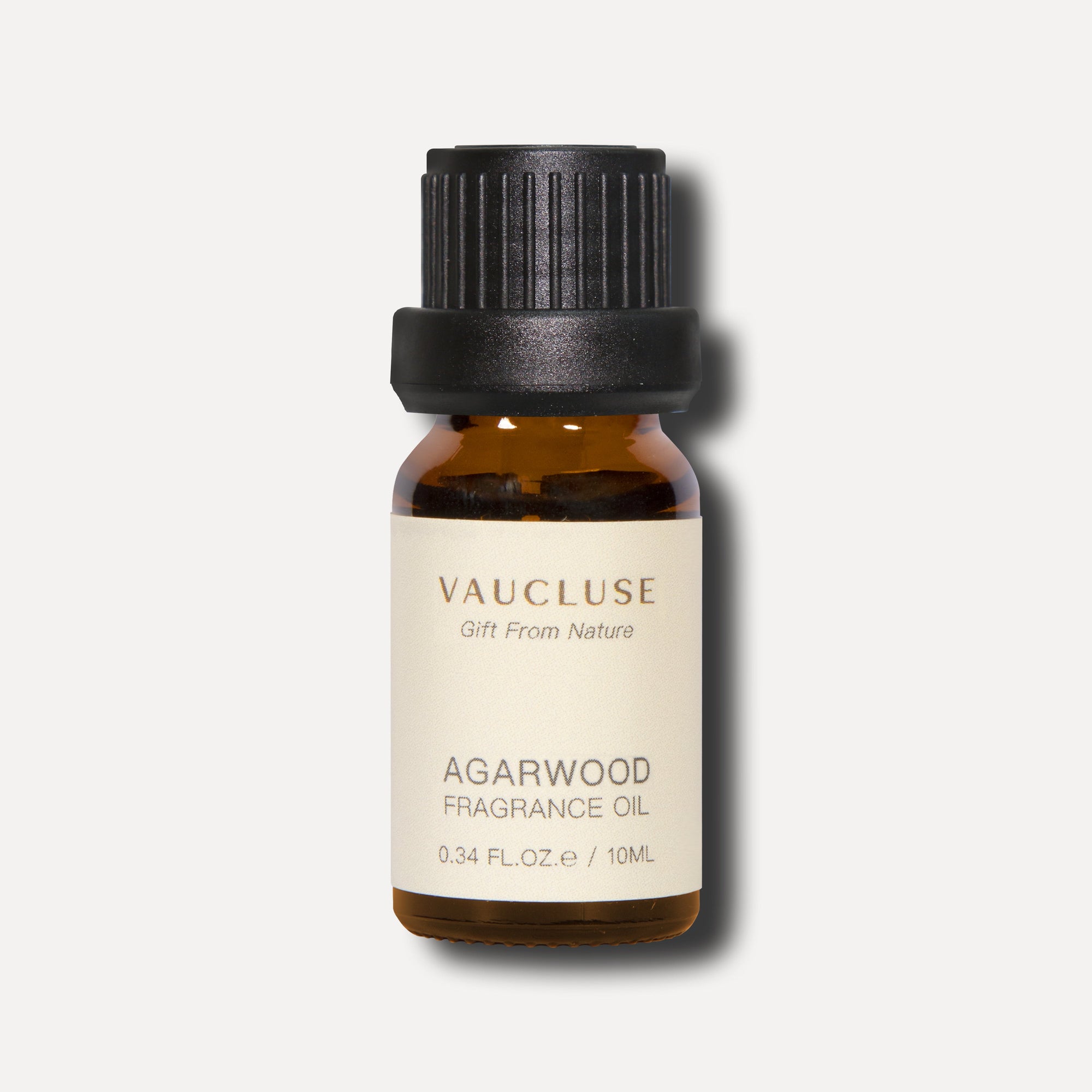 A single 10ml amber glass bottle of Vaucluse Agarwood Essential Oil with a black ribbed screw cap, casting a soft shadow on a clean background.