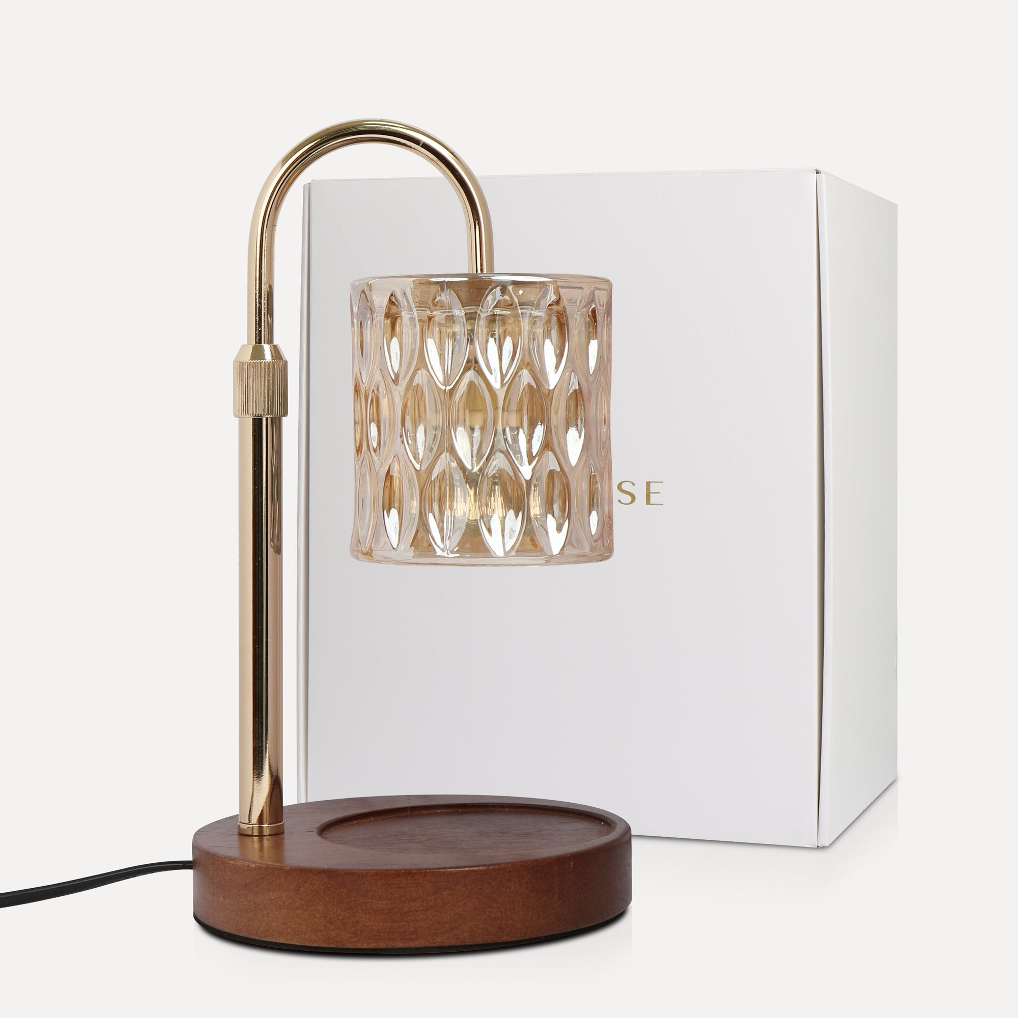 Vaucluse Fragrance luxury crystal candle warmer lamp featuring a beige tinted glass shade, curved gold arm, and a round wooden base next to its premium white gift box.