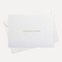 Front view of a minimalist luxury white congratulations card featuring elegant gold text and a blind-embossed floral border framework, displayed with its matching envelope.