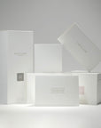 A collection of premium minimalist white Vaucluse fragrance gift boxes, candle packaging, and the "I Appreciate You" card neatly styled on a white surface.