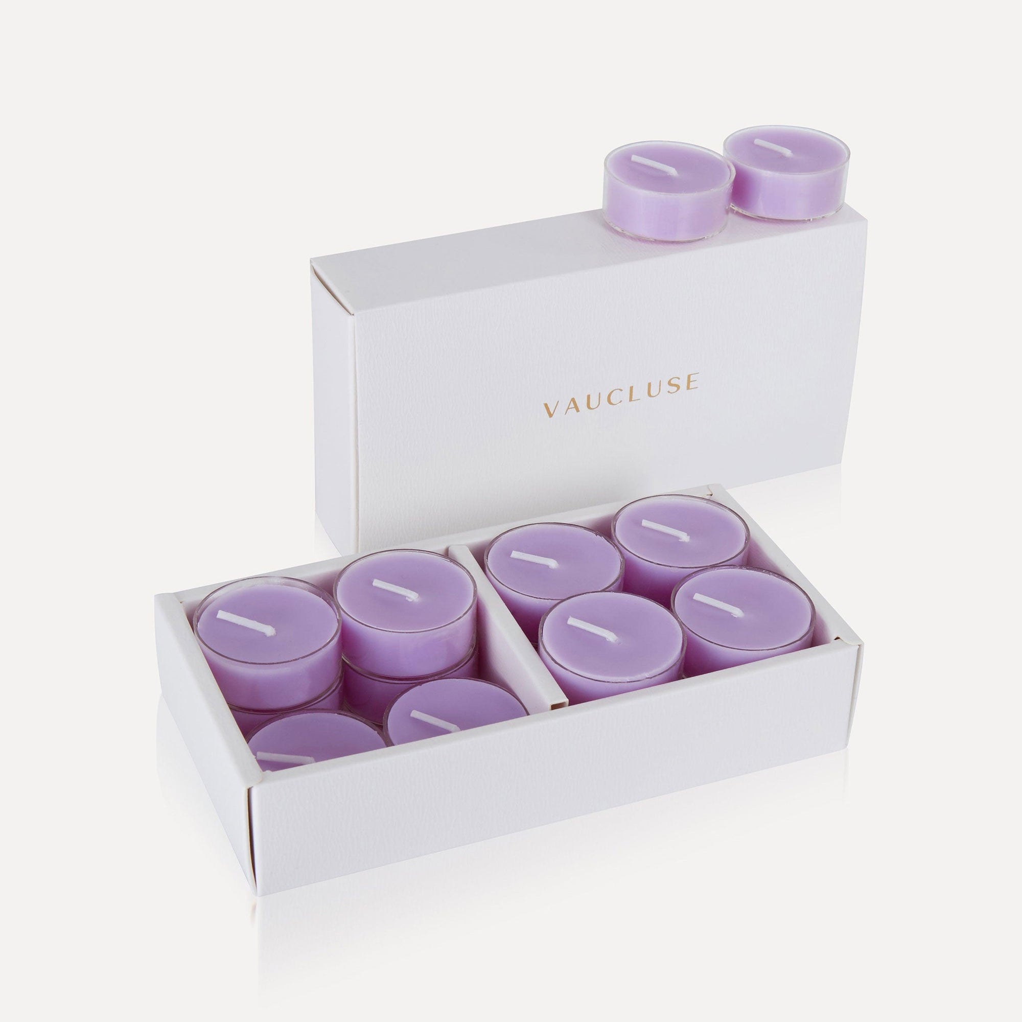 An open box of purple Vaucluse Lavender scented tealight candles showing a premium white presentation gift pack filled with soy tealights.