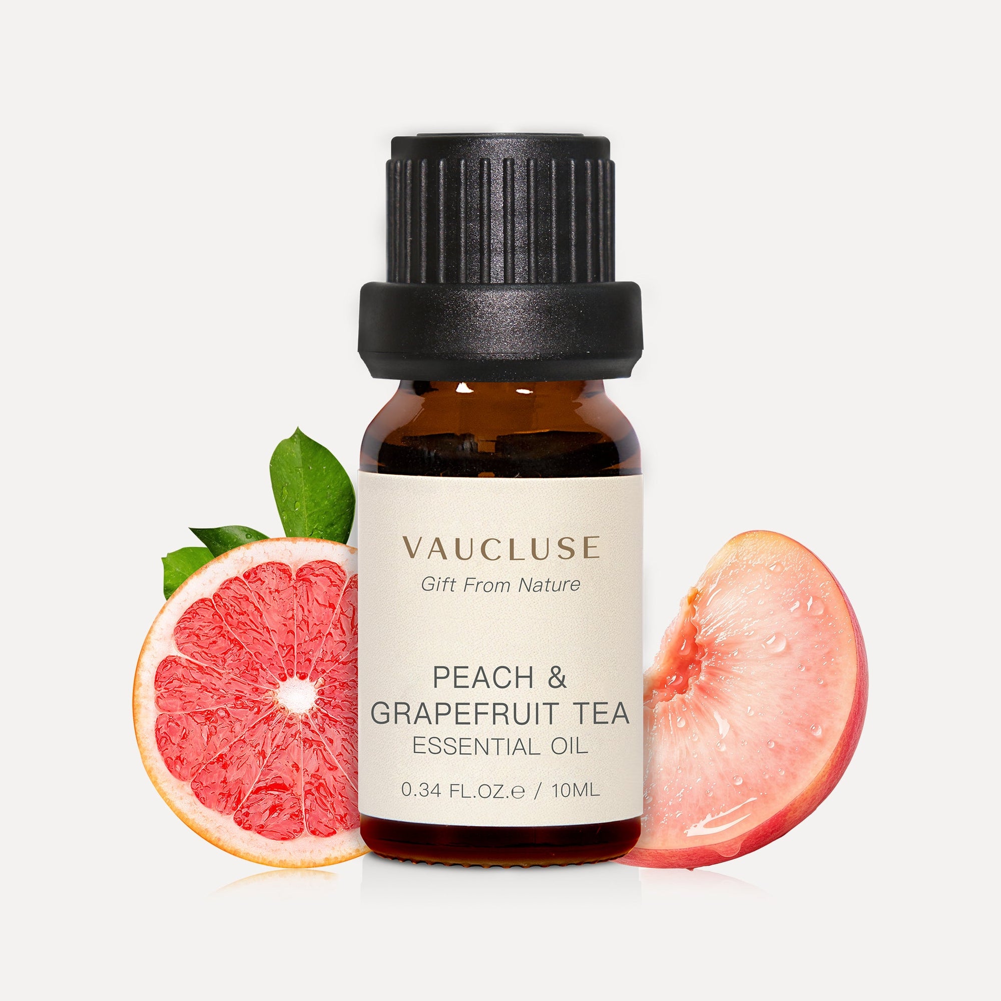 Vaucluse 10ml Peach and Grapefruit Tea essential oil amber bottle styled with fresh grapefruit and peach slices.