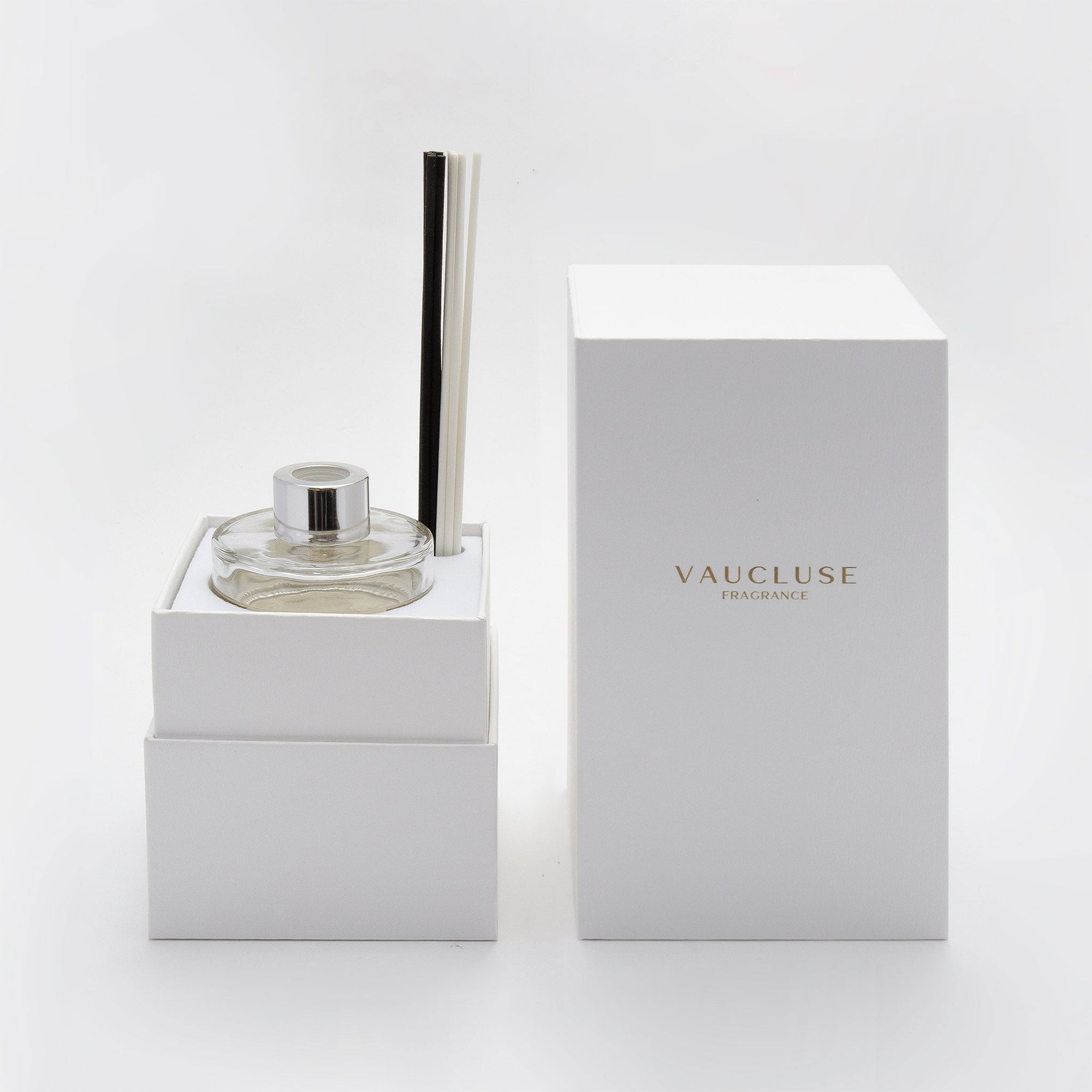 A close-up of the premium white Vaucluse gift box opened to reveal the secure, tailored interior compartment holding the glass diffuser bottle and its custom reed cap.