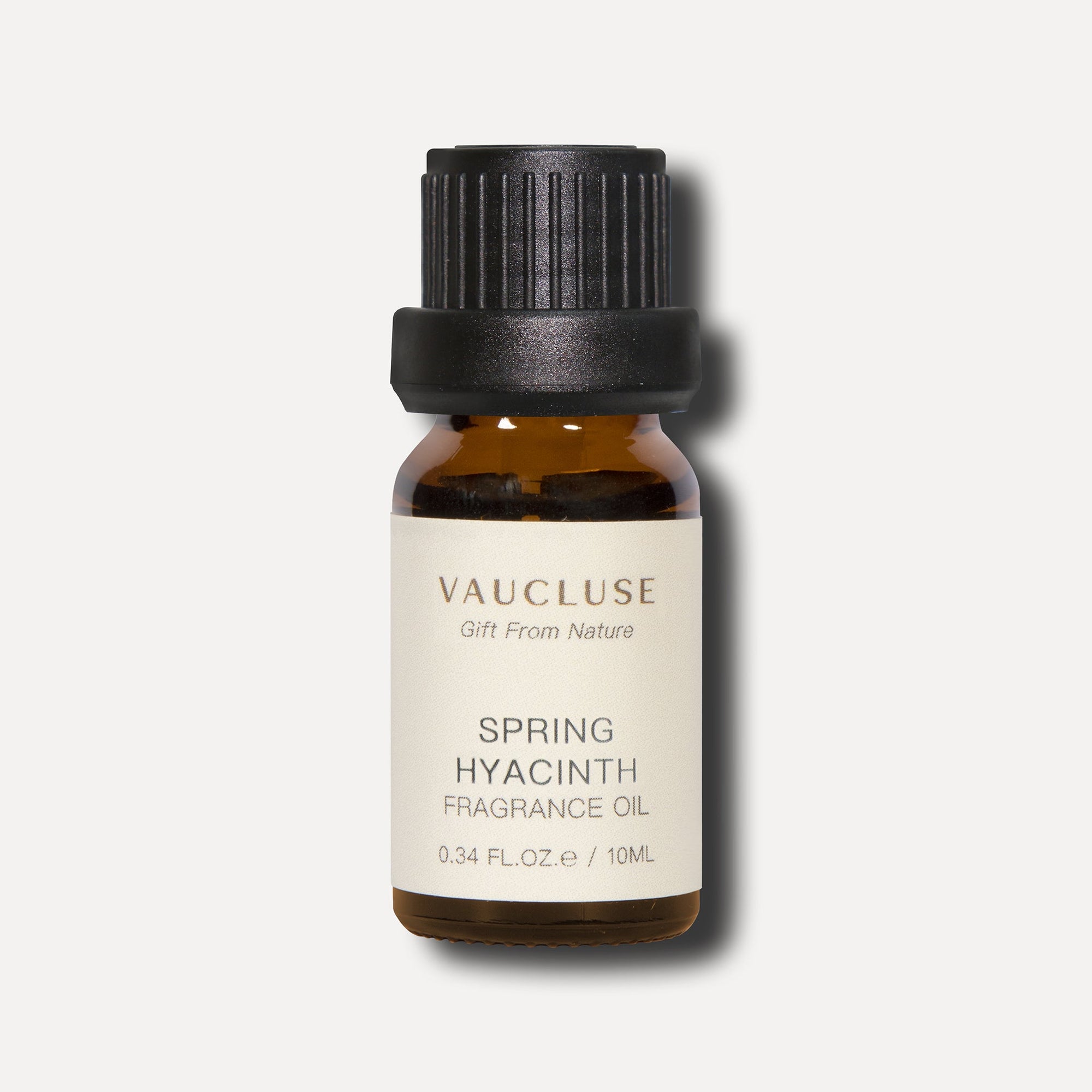 A clean studio front shot of a 10ml amber glass bottle of Vaucluse Spring Hyacinth Essential Oil with a black textured cap.