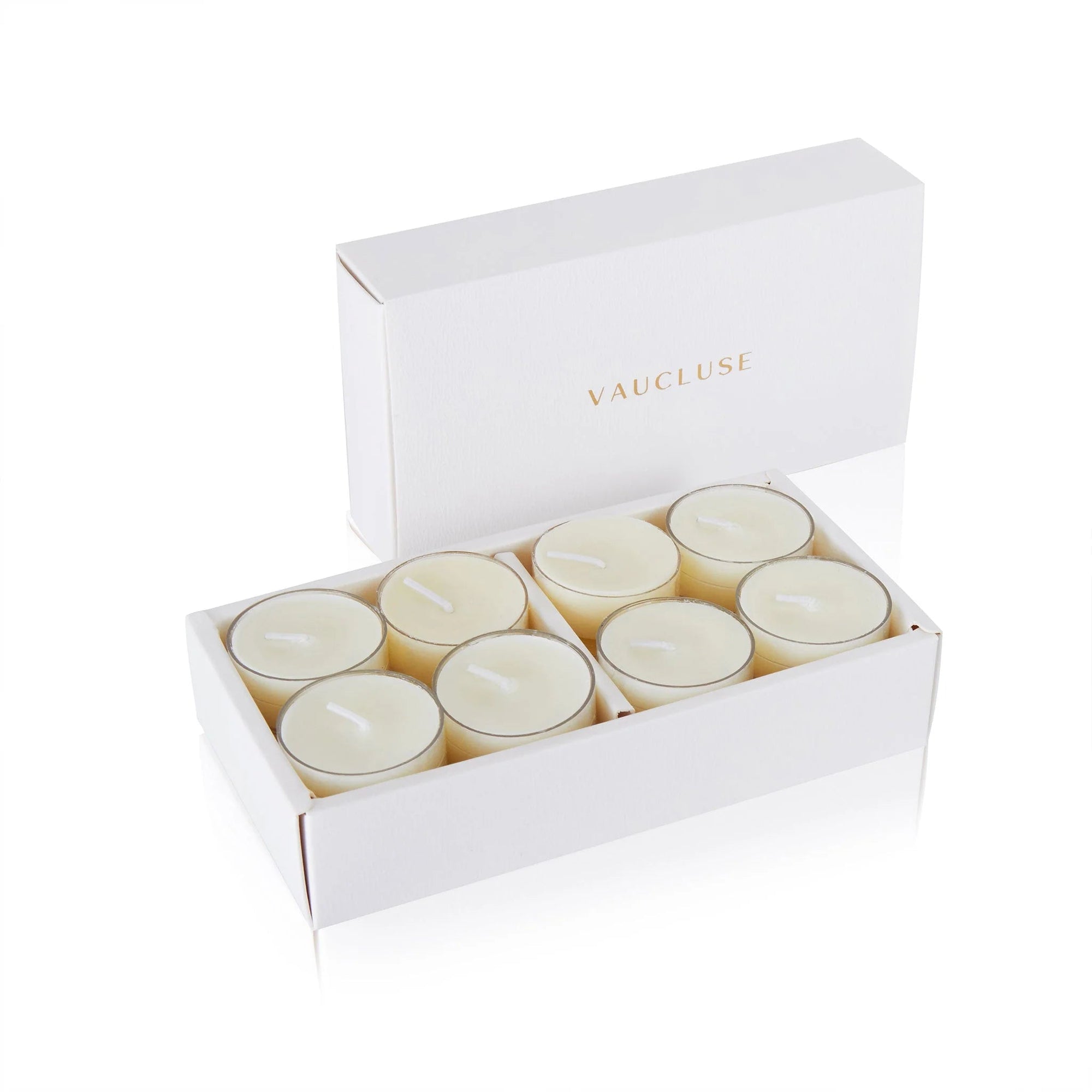 An open white Vaucluse luxury gift box displaying a set of clear cup vanilla scented tealight candles.