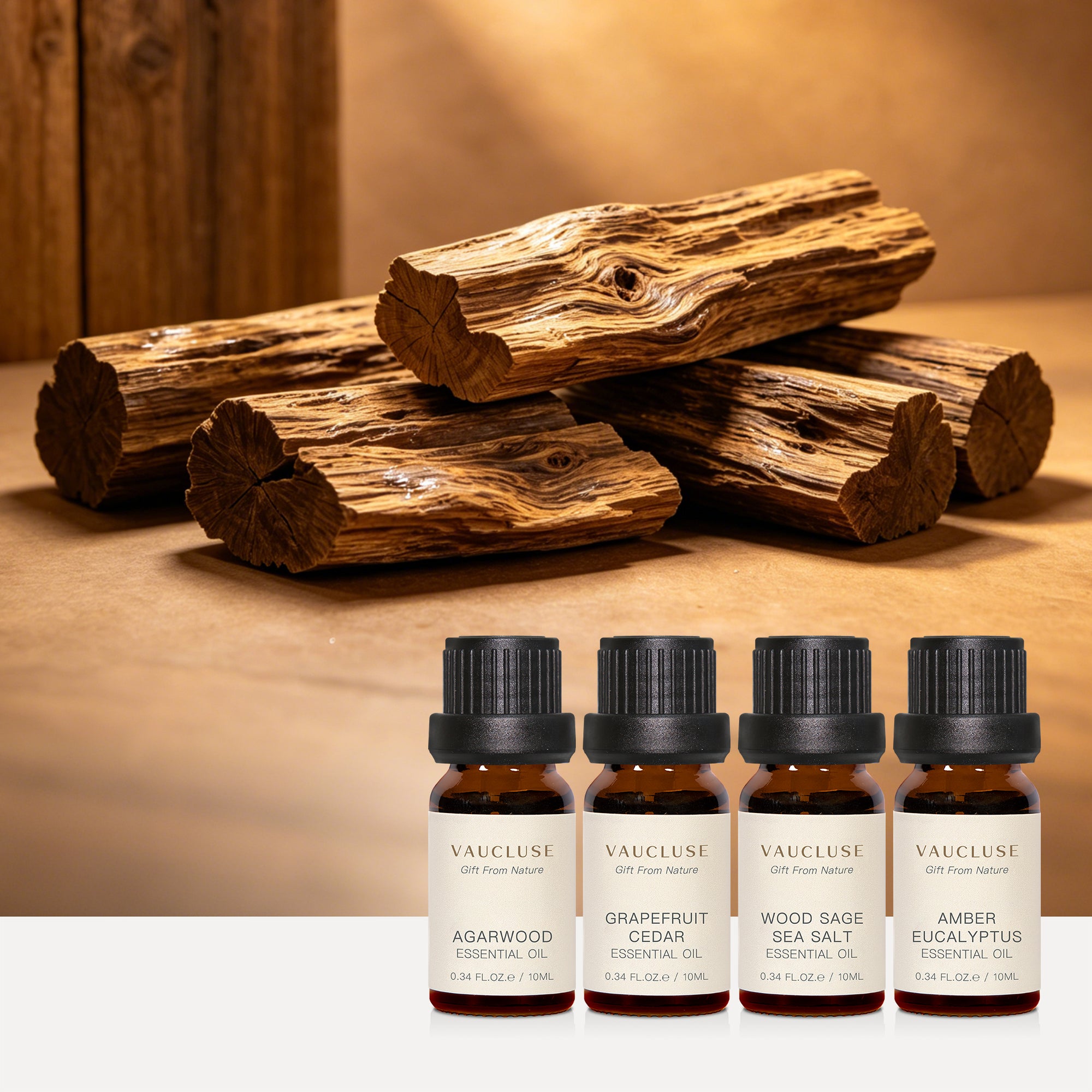 Vaucluse Woody & Earthy Collection essential oils featuring Agarwood and Grapefruit & Cedar, showcased with natural rustic wood logs.
